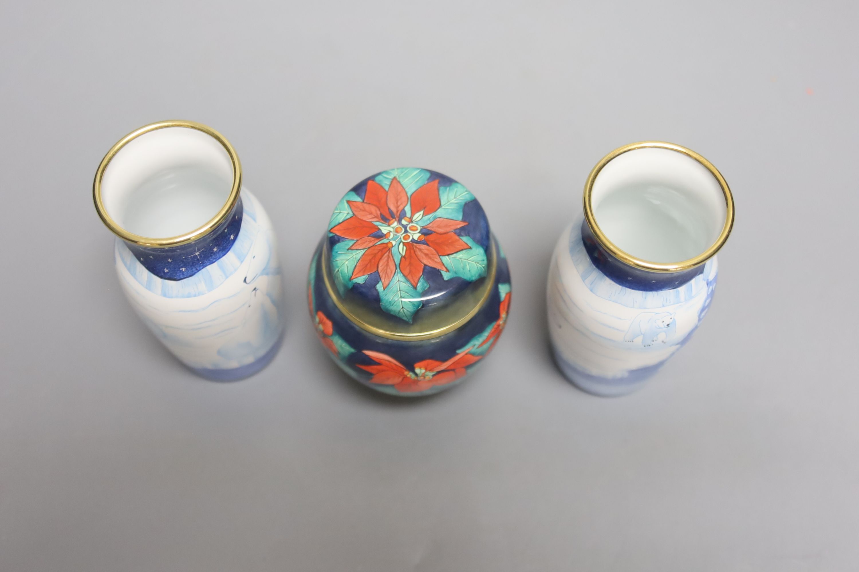 A pair of modern Moorcroft enamel on metal vases, decorated with polar bears, and a similar jar and cover, tallest 9cm
